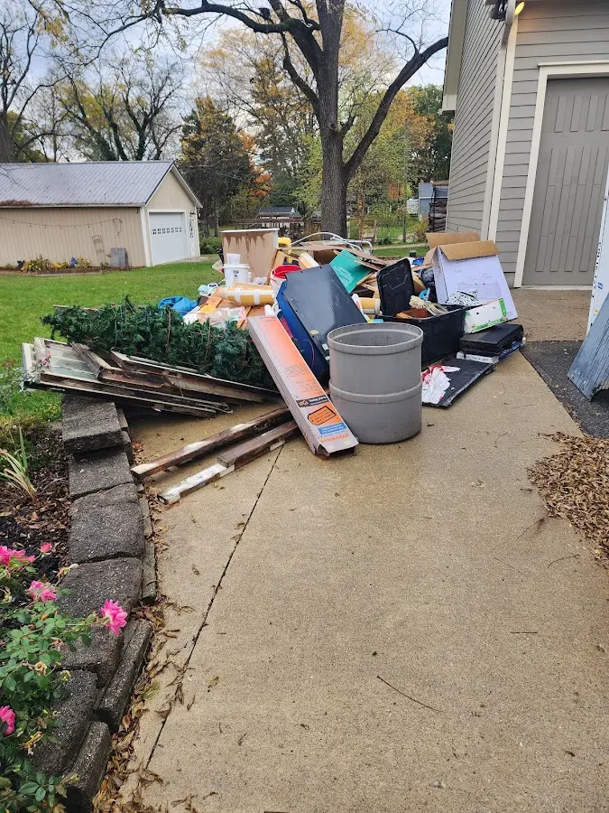 Dumpster being loaded with debris for 12 Yard Dumpster Rental in Milpitas